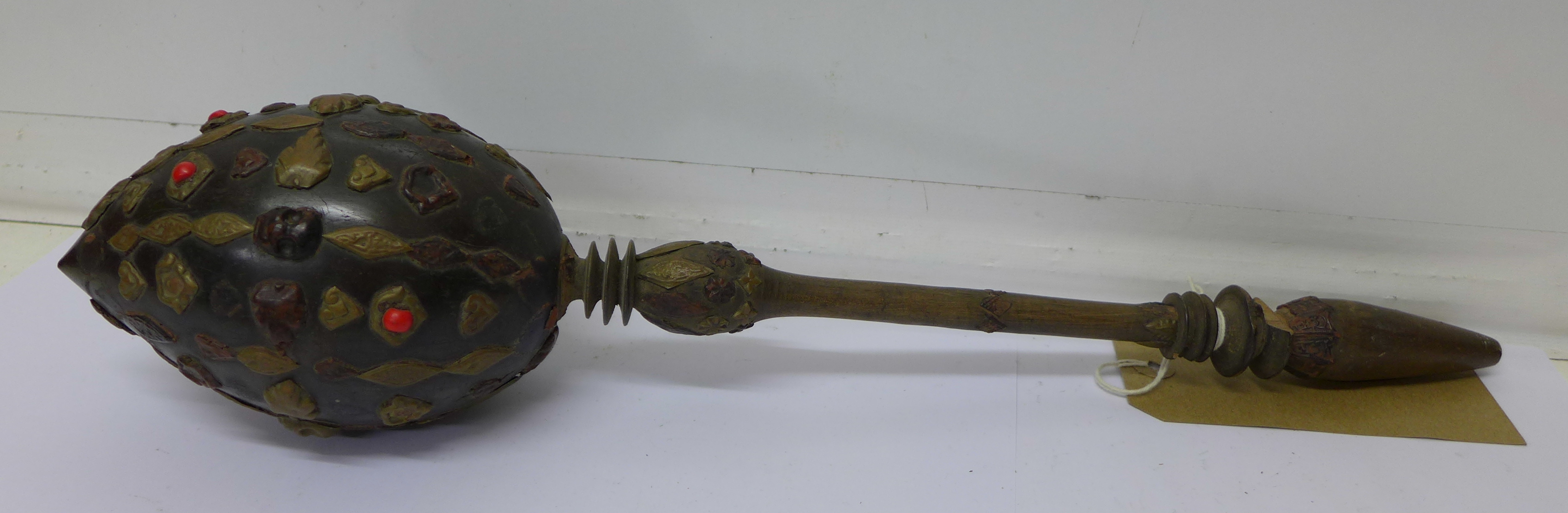 A decorated pipe made from a nut, possibly Mexican,
