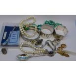 A turquoise necklace, a pearl bracelet and necklace with silver clasps,