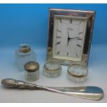 A silver framed clock, a silver handled button hook, etc.