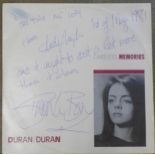 A Duran Duran Careless Memories 12" single, signed by Andy Taylor and Simon Le Bon,