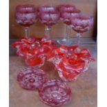 A set of seven red glass hock glasses decorated with grapes and vine leaves,