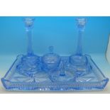 An Art Deco blue glass dressing table set