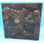 A bronze plaque with scene of Christ carrying the cross,