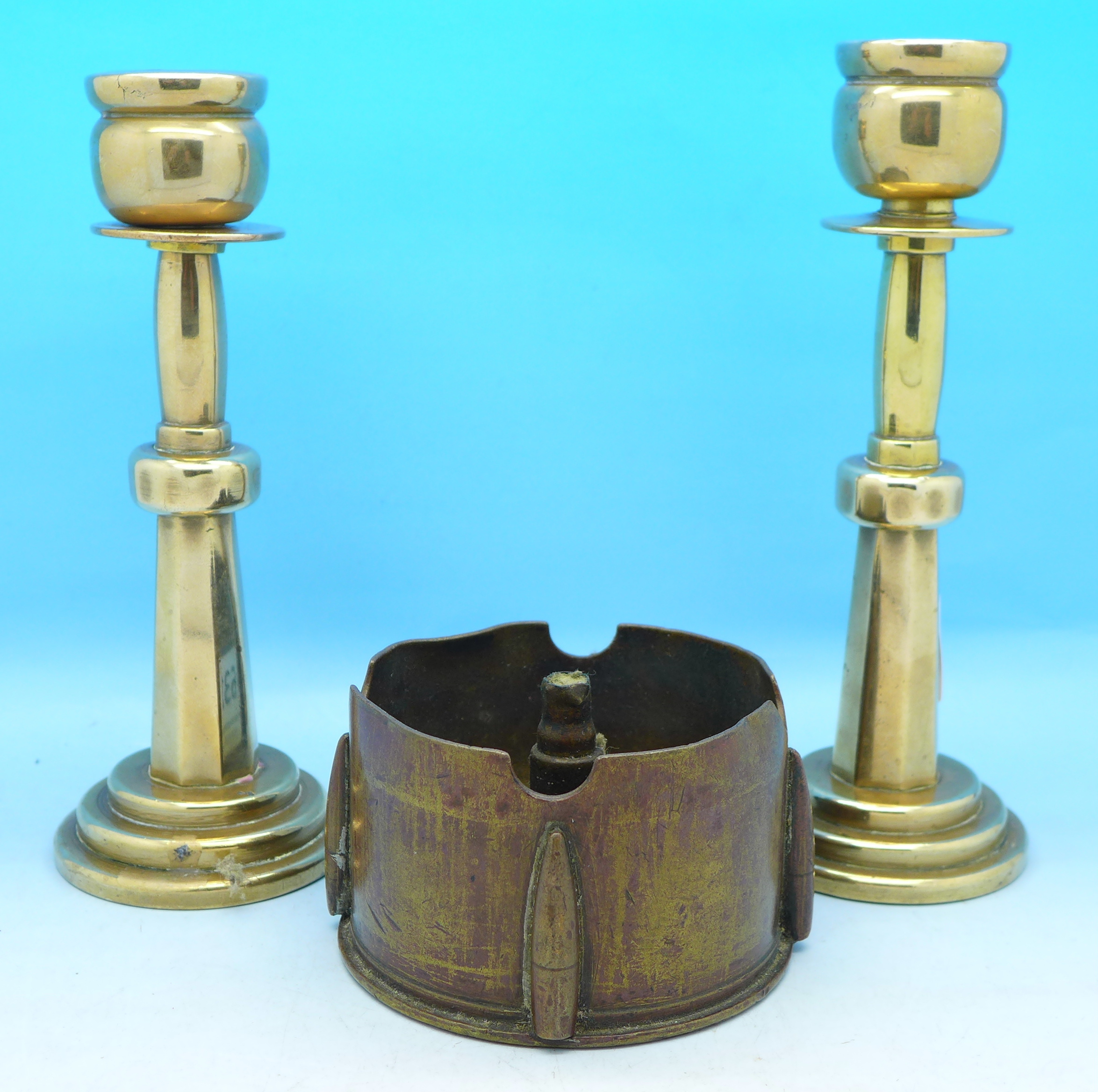 A trench art ashtray and a pair of candlesticks