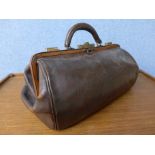 A vintage brown leather Gladstone bag