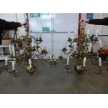 A pair of large Dutch style brass three tier chandeliers,