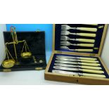 A cased set of scales and a cased set of fish knives and forks with silver ferrules in a fitted oak