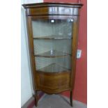 An Edward VII inlaid mahogany serpentine corner cabinet