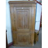 A George III pine freestanding corner cupboard