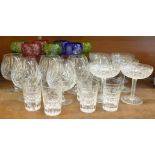 Seven hock glasses in blue, lime green and red, five champagne coupes,