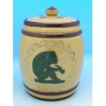 A Doulton Lambeth relief moulded tobacco jar and cover, with decoration of an ape smoking a pipe,