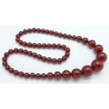 A set of sherry amber coloured beads, 69.