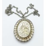 A large hallmarked silver locket on a silver chain