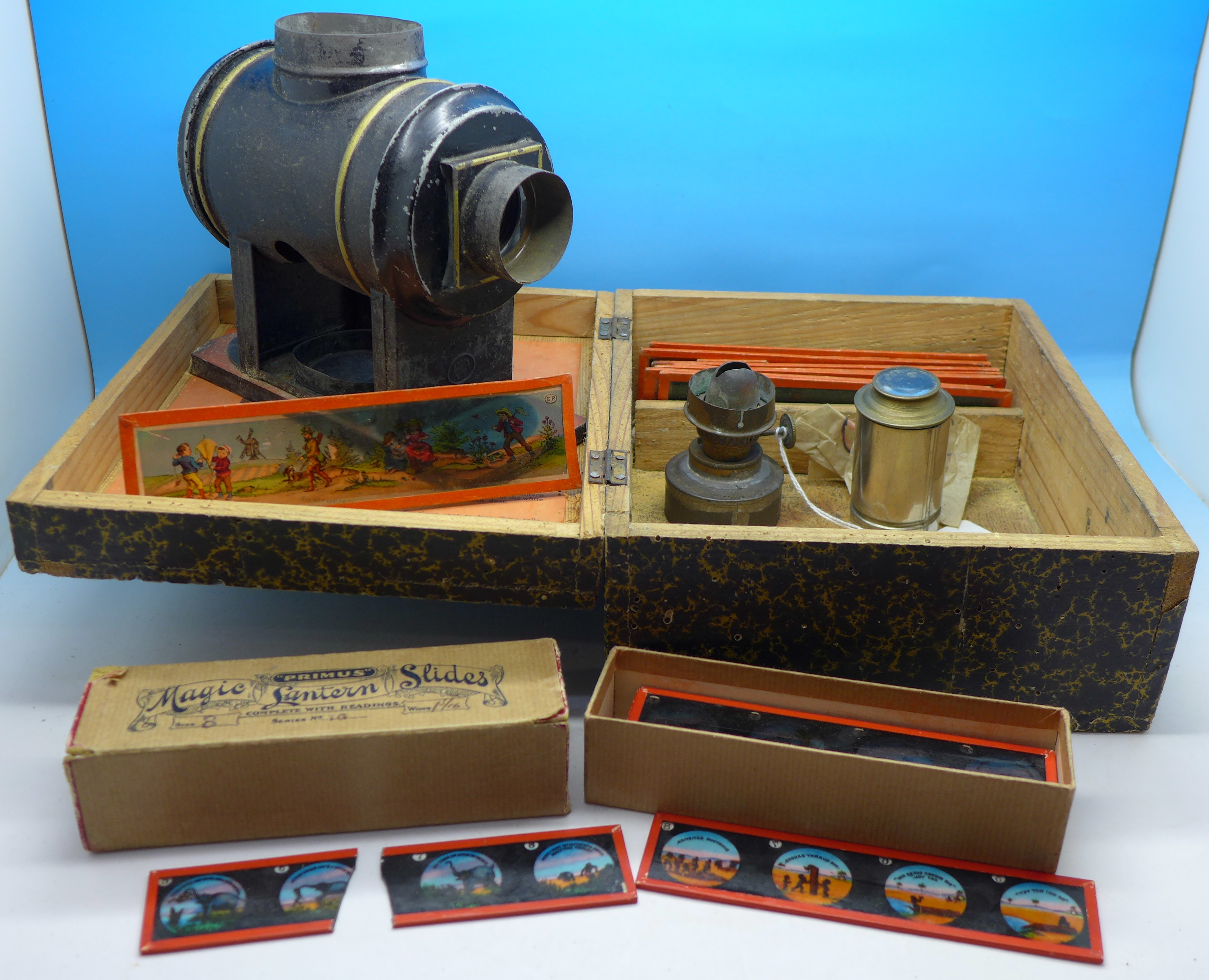 A boxed magic lantern with a box of slides and loose slides,