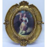 A gilt framed oval picture of a girl dancing