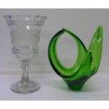An etched glass celery vase and a green glass dish