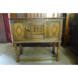 A 17th Century style carved oak livery cupboard