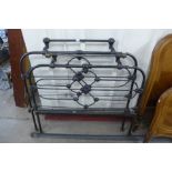 A Victorian cast iron and brass 4ft bed