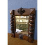 A small 17th Century style carved oak mirror