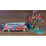 A clockwork tin-plate ferris wheel and a tin-plate fire tender,