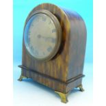 An early 20th Century arch top clock with faux tortoiseshell case and gilt metal feet,