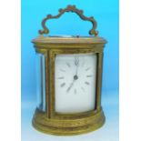 An oval brass and four glass sided chiming carriage clock, 13.