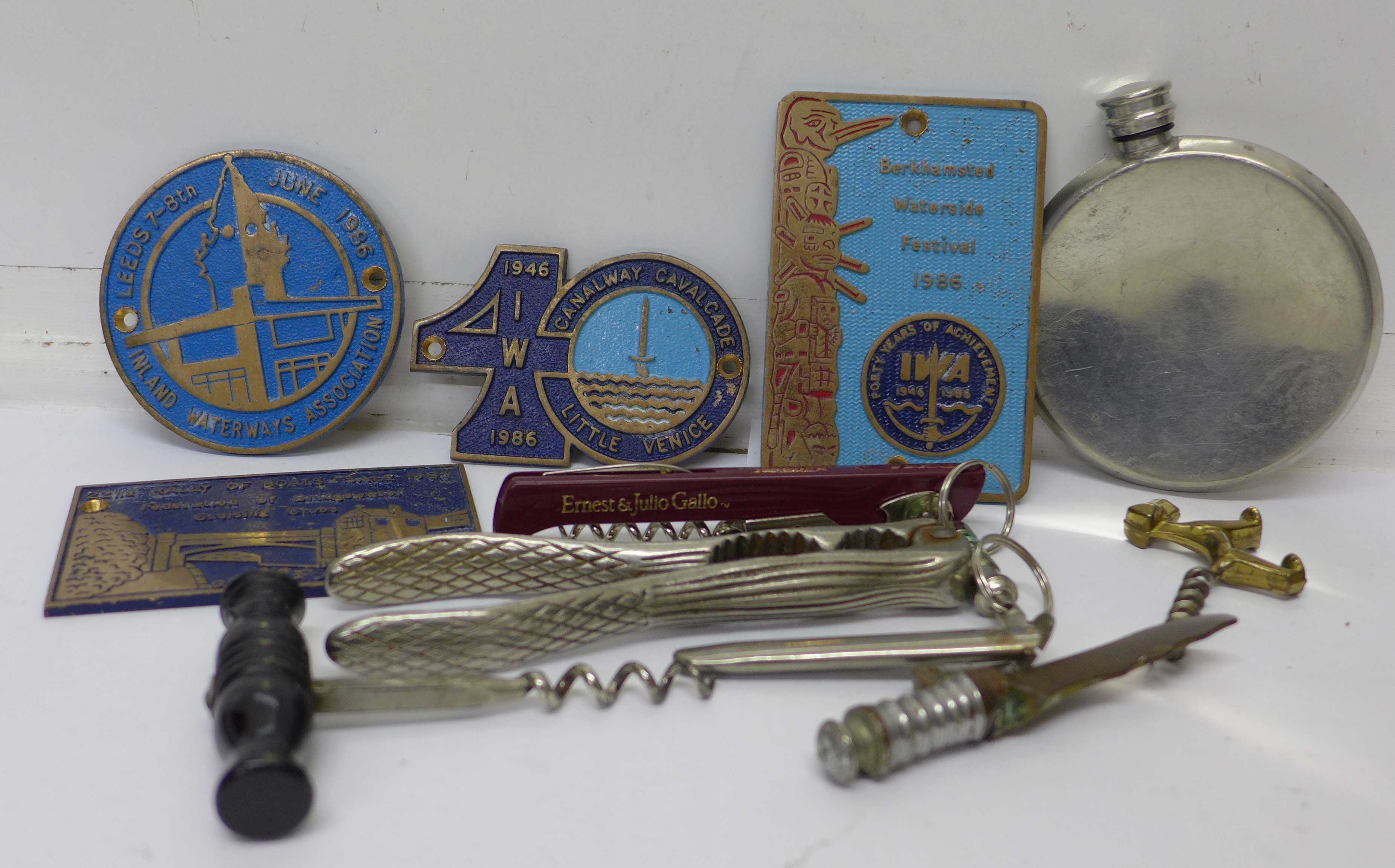 Four brass plaques, corkscrews, a hip flask, etc.