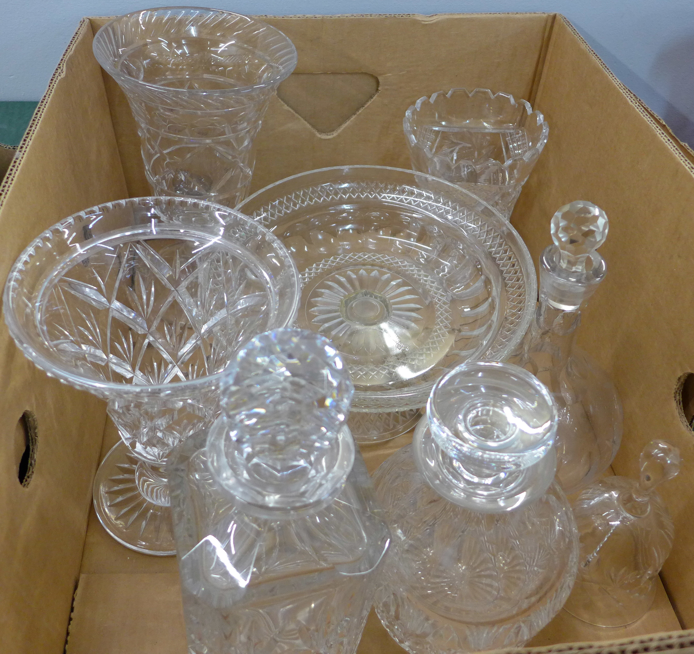 A collection of lead crystal and cut glass, including two decanters, vases, etc.