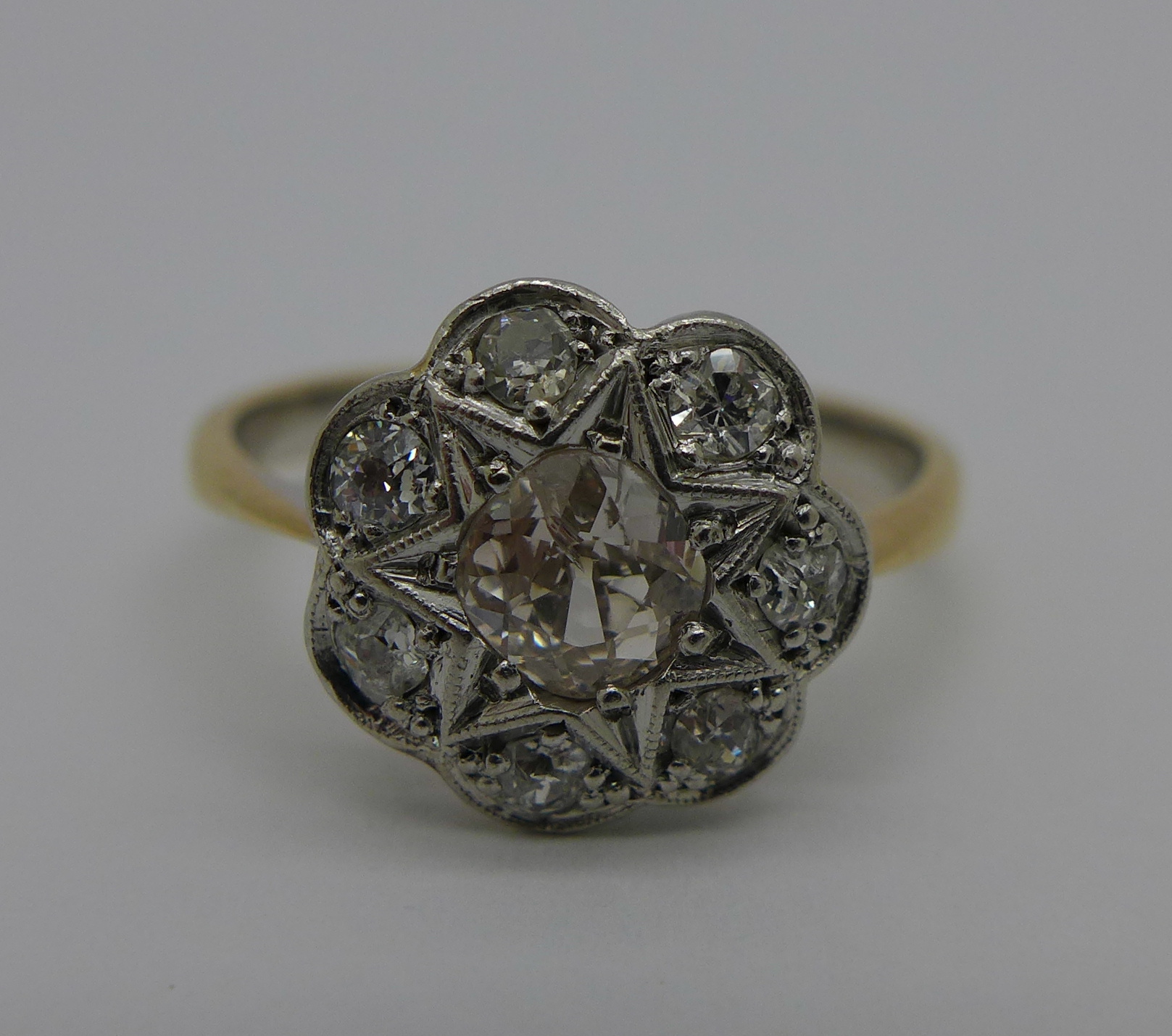 An 18ct gold Art Deco cluster ring set with old mine cut diamond centre stone, c.