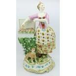 A Staffordshire figure of a lady selling fruit with dog companion, 25.