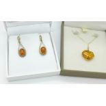 A pair of 9ct gold and amber earrings and an amber pendant on a 9ct gold chain