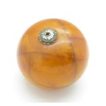 A large amber coloured bead, 5.