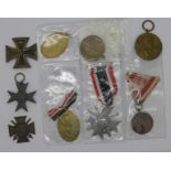 A German 1939 cross medal, a/f, and eight other medallions,