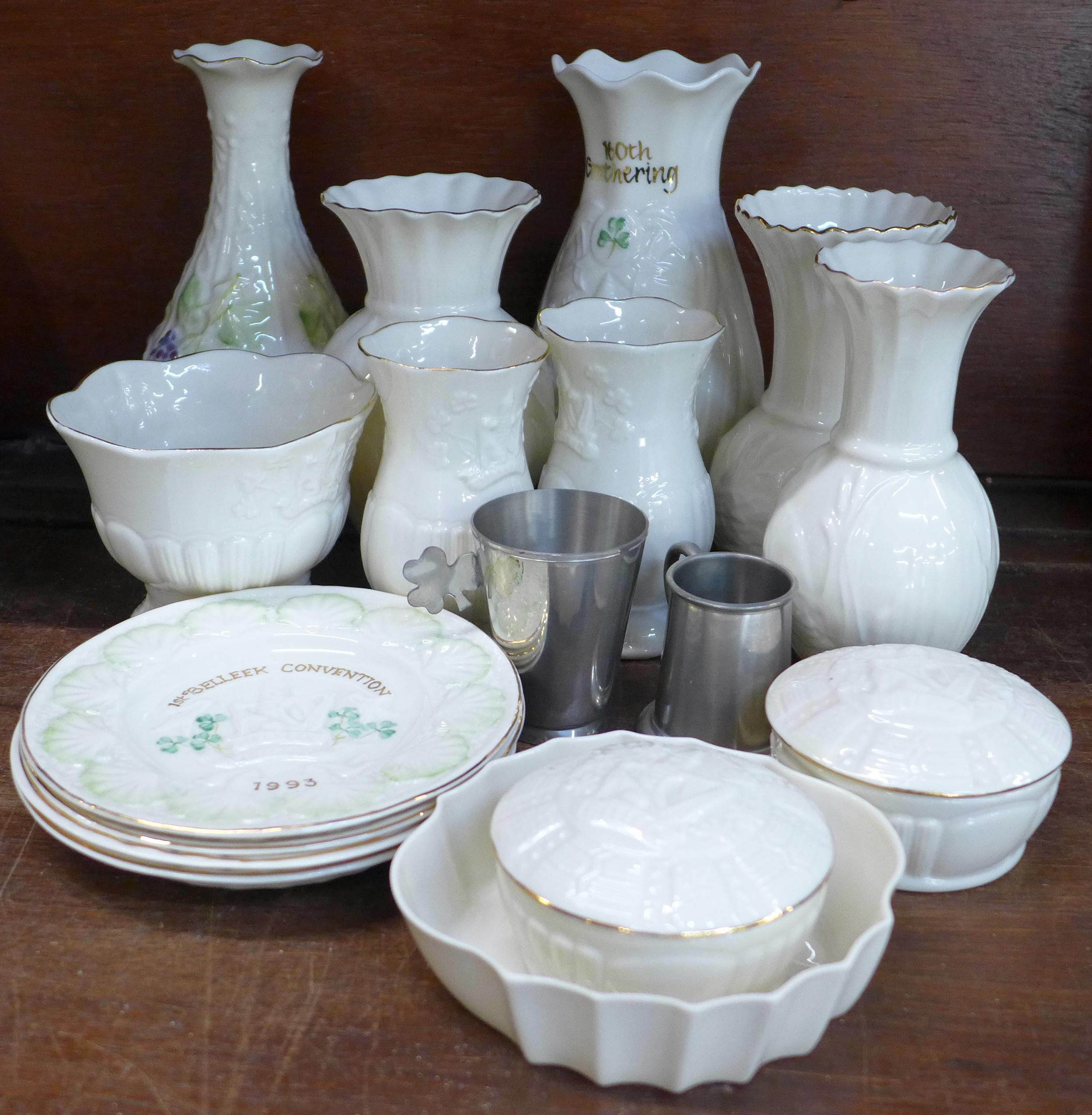 Fifteen Belleek vases and plates and two Irish pewter cups,