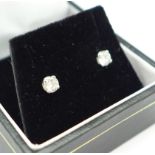 A pair of 18ct white gold and diamond stud earrings, total diamond weight 0.