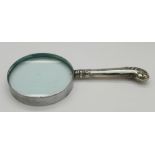 A silver handled magnifying glass,