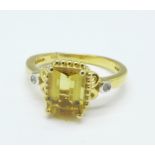 A silver gilt ring set with marialite and with diamond accents,