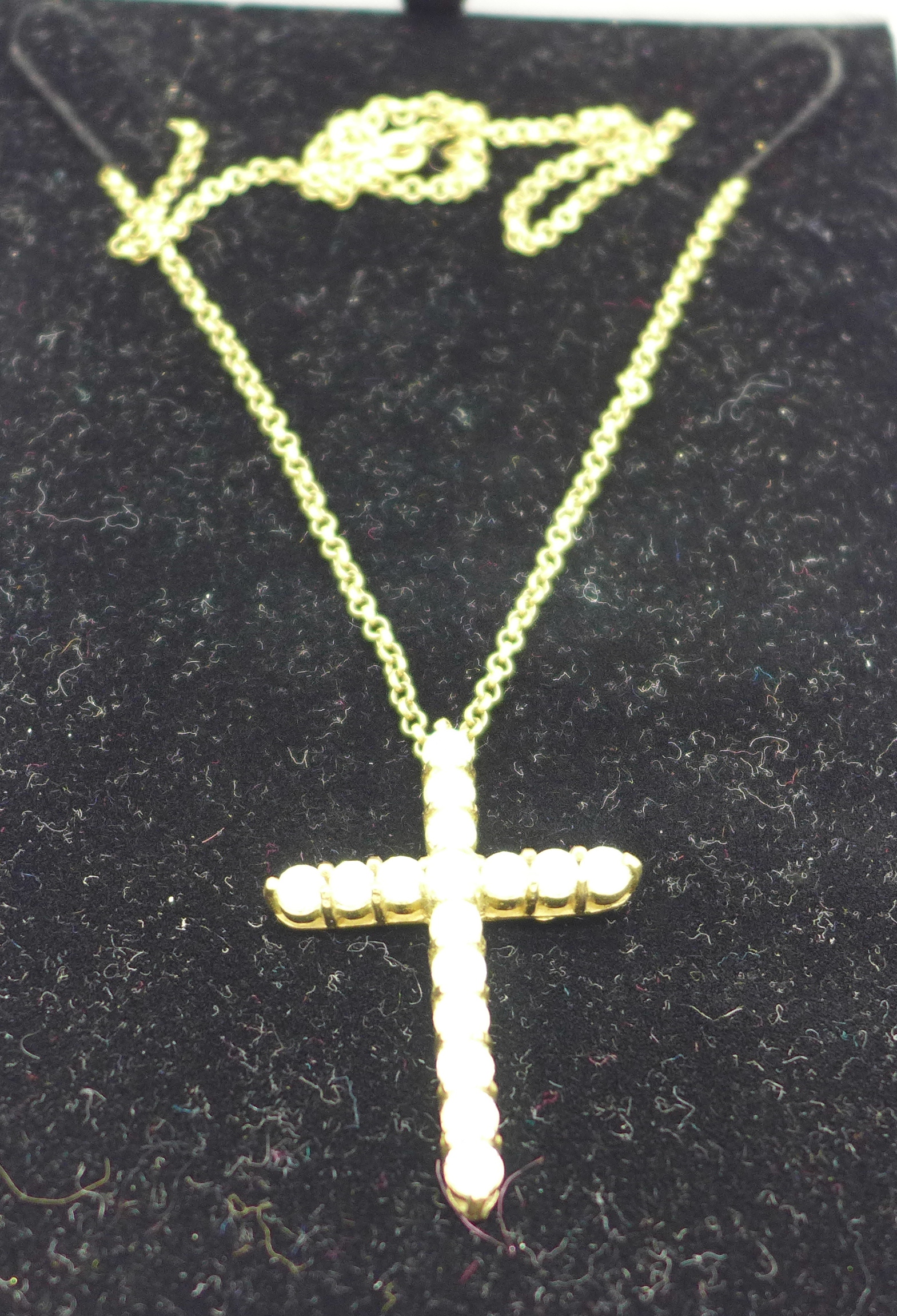 A 9ct gold stone set cross pendant,