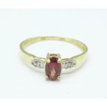 A 9ct gold, garnet and diamond ring, 1g,