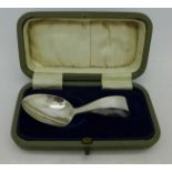A silver feeding spoon, cased,
