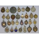 A collection of twenty four hallmarked silver fob medals, mainly cricket related,