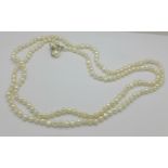 A long silver mounted pearl necklace