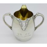A Victorian silver 'tulip' cream pourer with double spout, bears inscription,