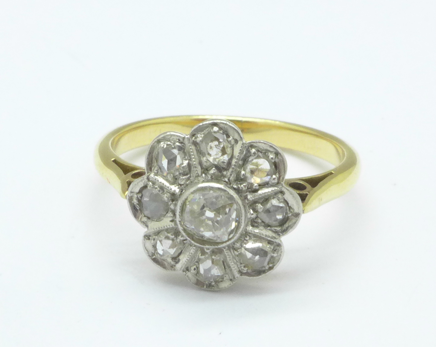 A yellow metal and diamond flower ring, 3.