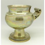 A silver cup with handle, hallmarked London 1911, by Stewart Dawson & Co. Ltd.