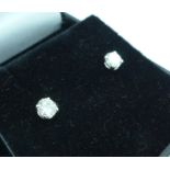 A pair of 18ct white gold and diamond stud earrings, total diamond weight 0.