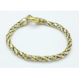 A yellow and white metal bracelet set with a pearl, marked 750,