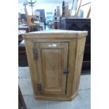 A pine hanging corner cupboard