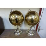 A pair of globes on stands