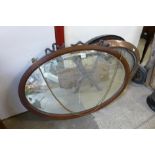 An Arts and Crafts oval copper framed mirror,